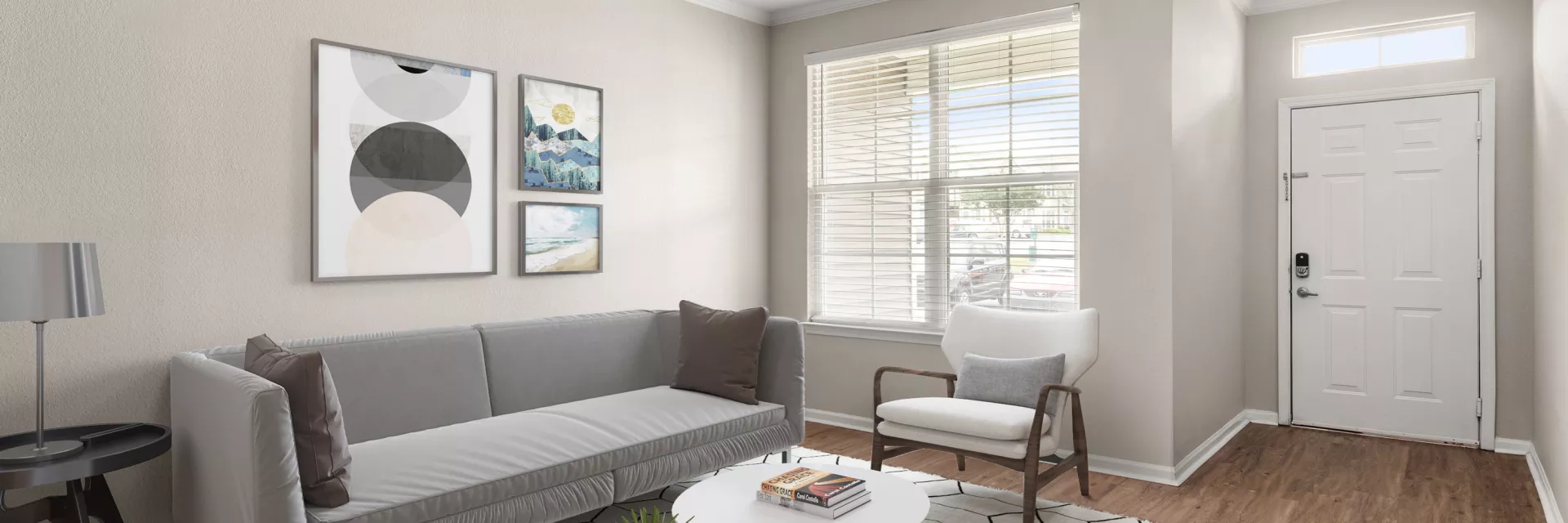 Modern living room with gray sofa, white armchair, geometric rug, and white door.