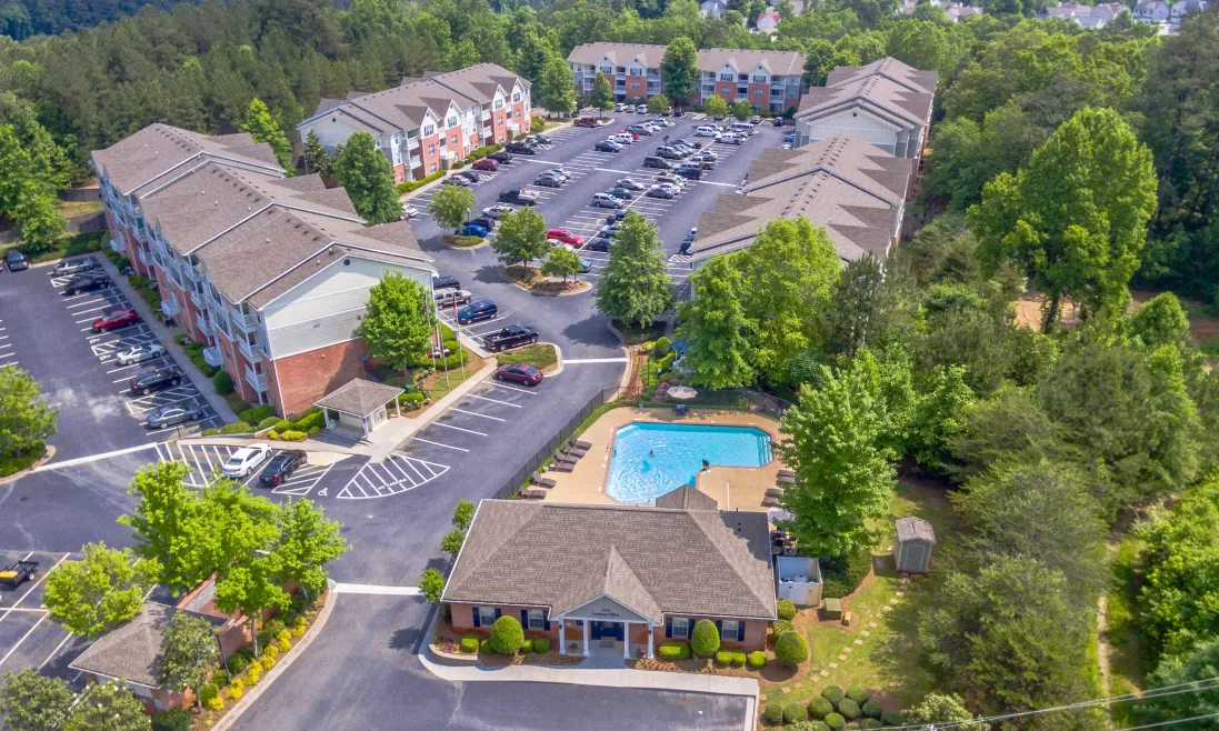 Aerial view of apartment buildings, leasing office, and pool